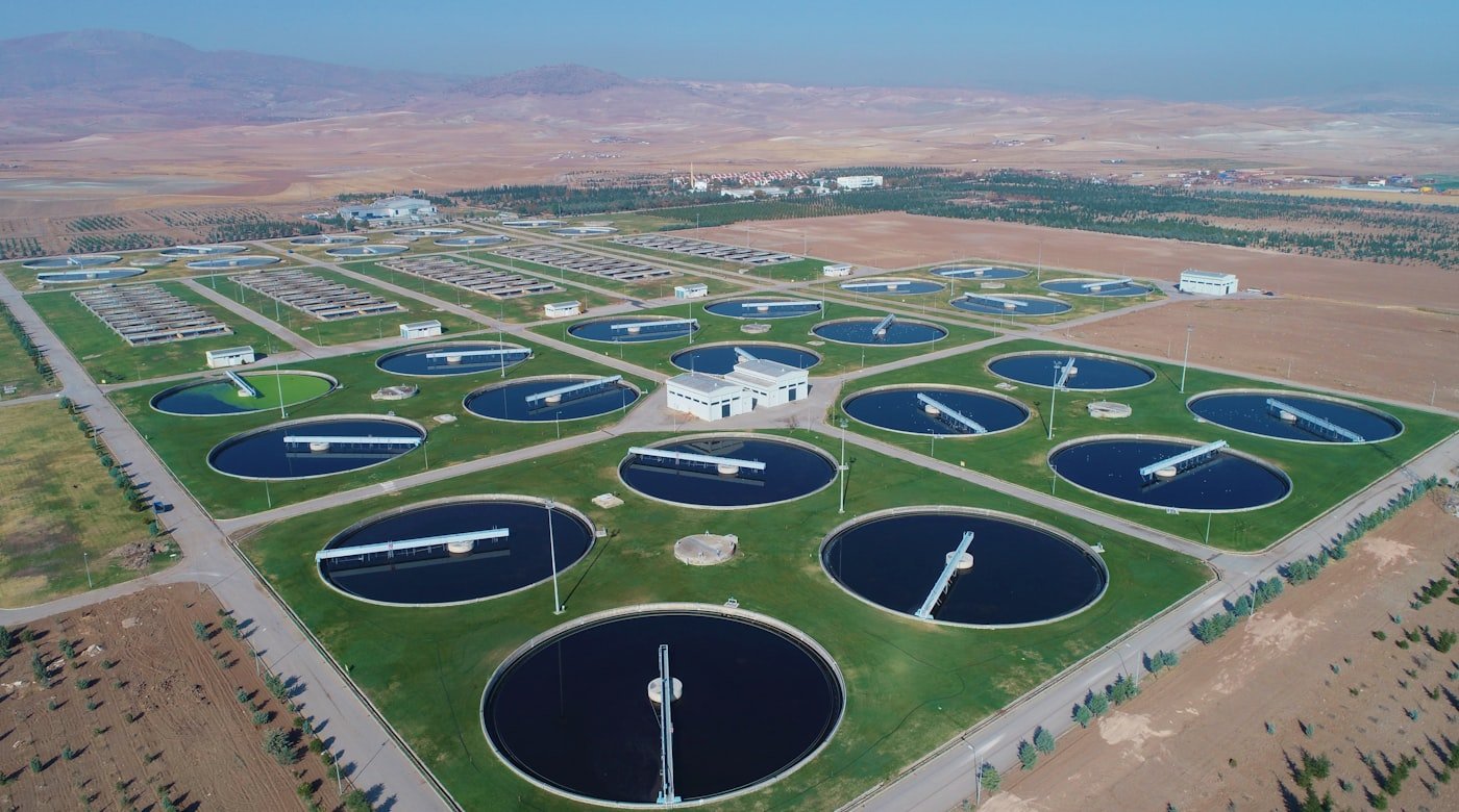 Aerial view of a water treatment plant with circular clarifier tanks